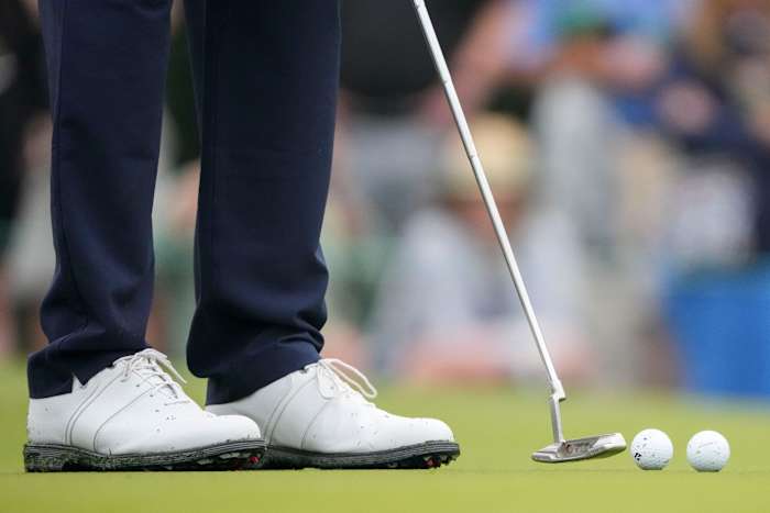 View of Tiger Woods' white golf shoes.
